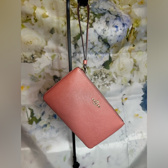 Coach Handbags - Coach factory light pink large wristlet GUC